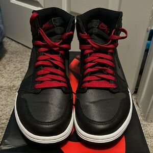 Black Nike Air Jordan retro high tops. Red laces and lettering. Size 10 1/2.